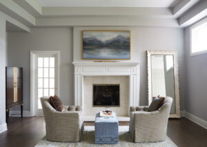 white den with cozy fireplace and tray ceiling