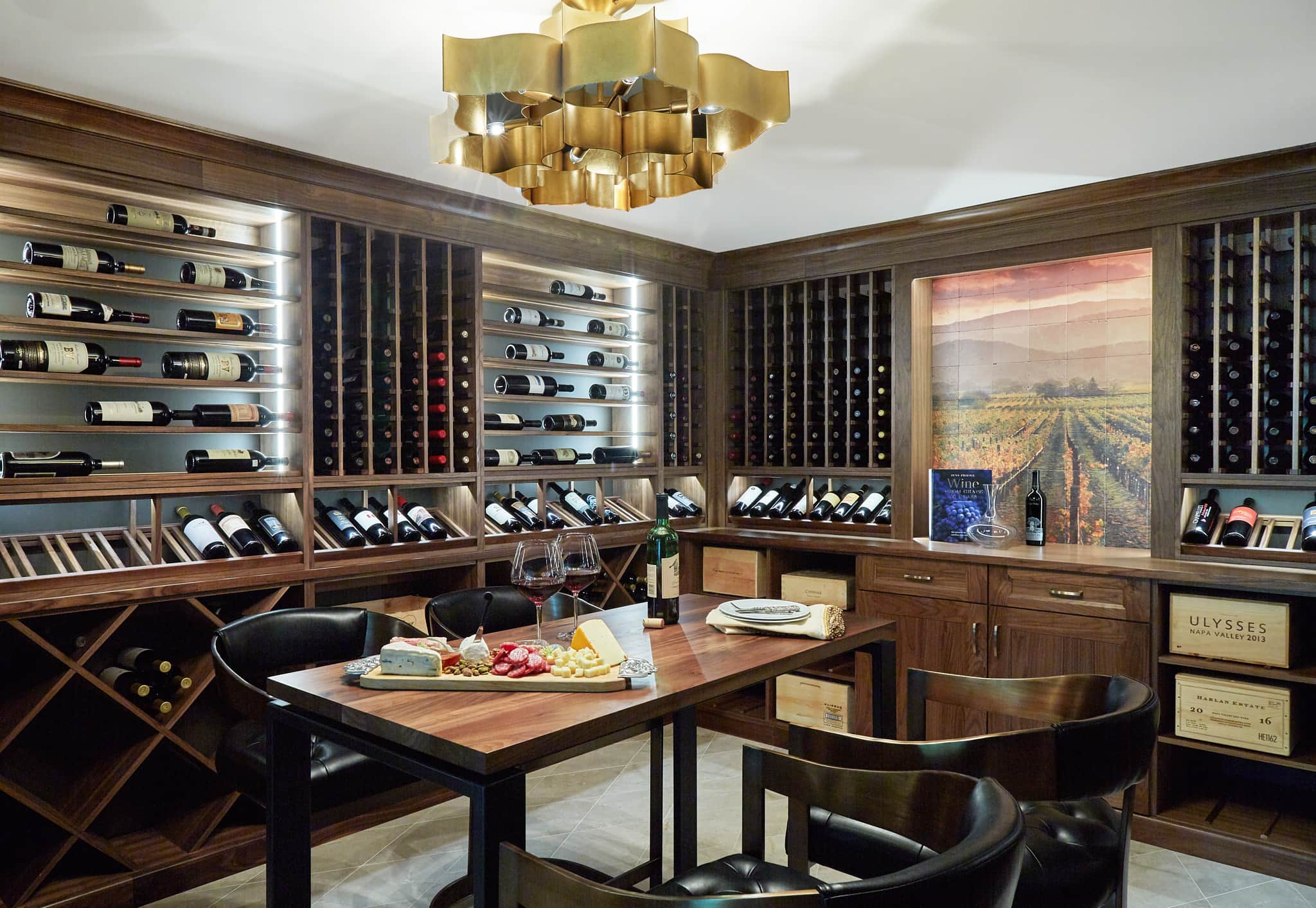 wine room with wood wine racks along the walls and a high tasting table in the center of the room.