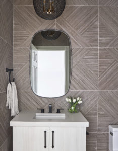 powder room vanity, mirror, walls, and light fixture